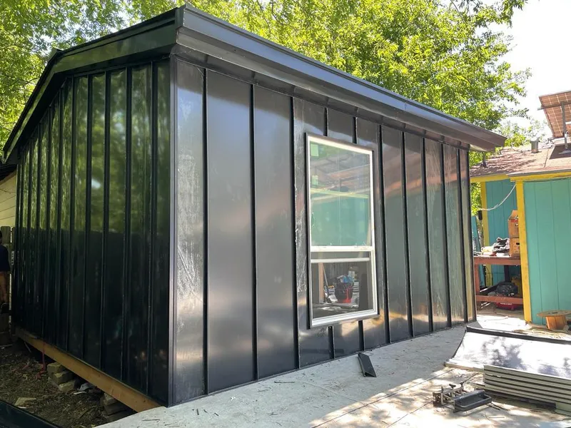 Black standing seam metal wall panels for Roof Inspection in North Stonington