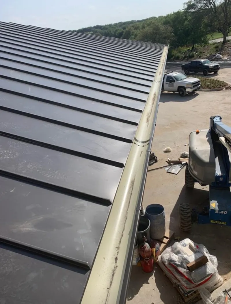Standing seam panel and gutter detail on a metal roofing jobsite in North Stonington